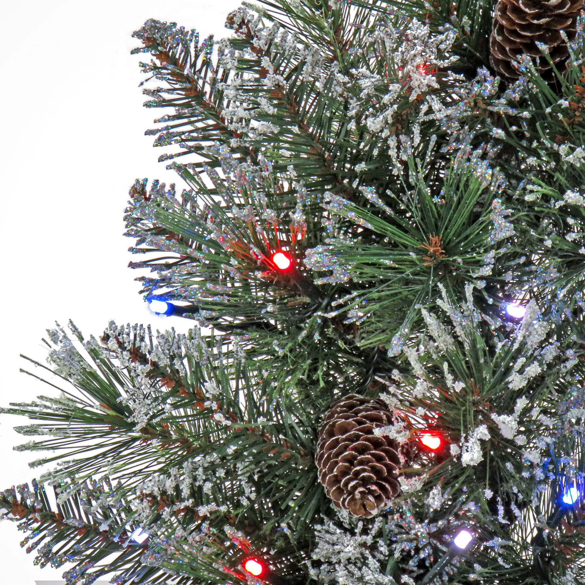 24" Glittery Bristle® Pine Porch Bush in Dark Bronze Plastic Urn with White Tipped Cones